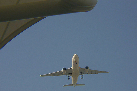 Passenger Jumbo Jet Flying Over the Track