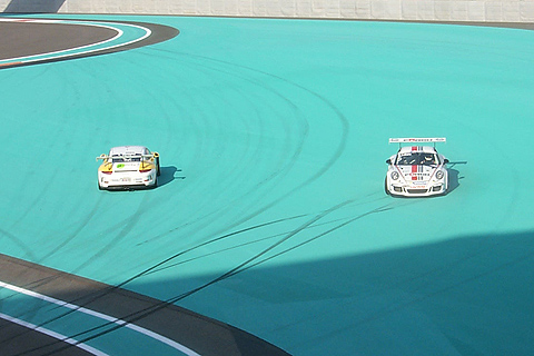 Two Porsche 911 GT3 cars Facing Opposite Directions