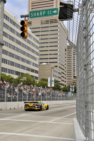 Corvette on Front Straight in Front of Buldings