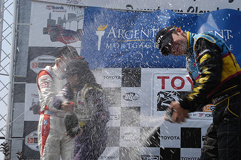 Drivers Spraying Champagne At Each Other