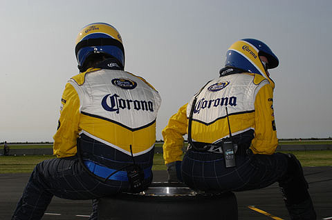 Two Crew Members Resting On Tires