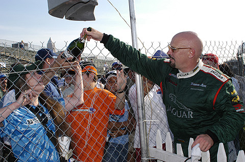 Paul Gentilozzi Giving Champagne Bottle to Fan