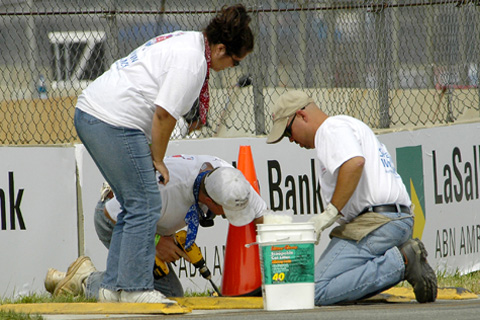 Three Workers Screwing Cone Down