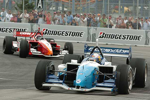 A.J. Allmendinger Leading Justin Wilson