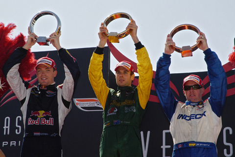 Top Three on Podium Holding Trophies