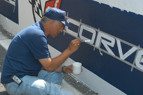 Crew Member Painting The Pit Wall