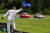 Corner Worker Waving Blue Flag at Trio of Cars Thumbnail