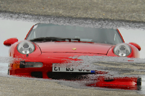 Reflection of Porsche in Puddle
