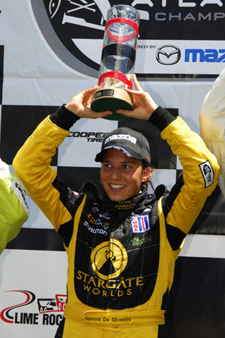 Simona De Silvestro w/Trophy on Victory Stand