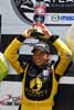 Simona De Silvestro w/Trophy on Victory Stand Thumbnail