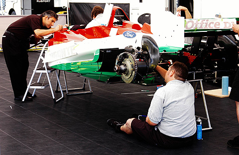 Putting The Stickers On Michel Jourdain's Car