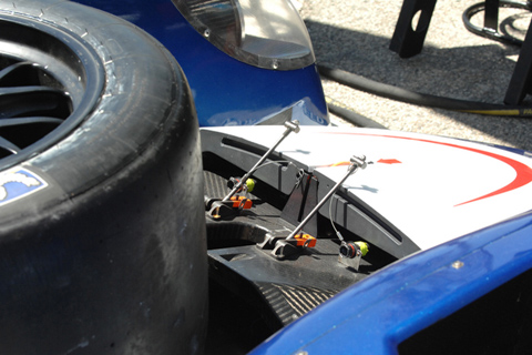 Tire and Car Parts Behind Pits for Servicing