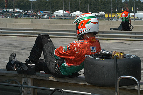 Fernandez Crew Member Relaxing Against Tire