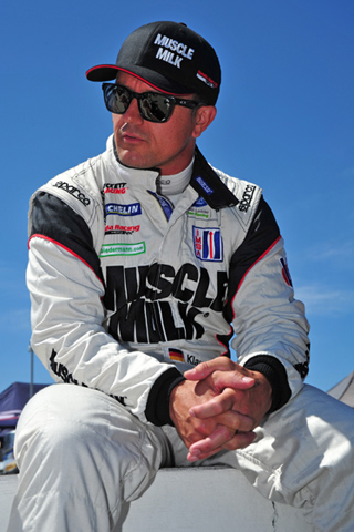 Klaus Graf sits on wall during pre-race procedures