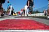 Fans milling around on pre-grid walk near curbing Thumbnail