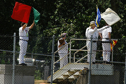 Corner Workers Waving All The Flags