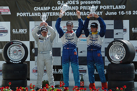 Top Three Holding Trophies on Podium