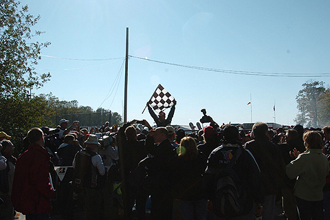 A.J. Allmendinger Holds Up Checkered Flag