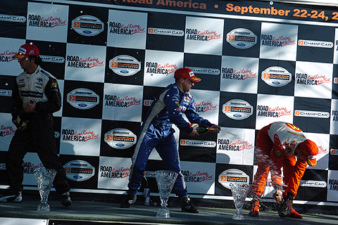 A.J. Allmendinger Spraying Sebastien Bourdais On Podium