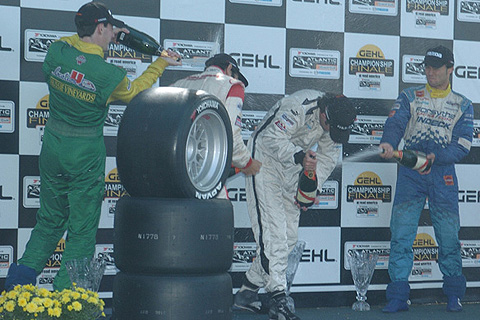 Winners Spraying Champagne on Podium