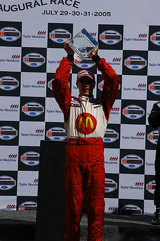 Sebastien Bourdais Holding Trophy Aloft On Podium