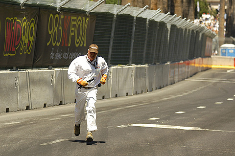 Corner Worker Running Across Track w/Debris