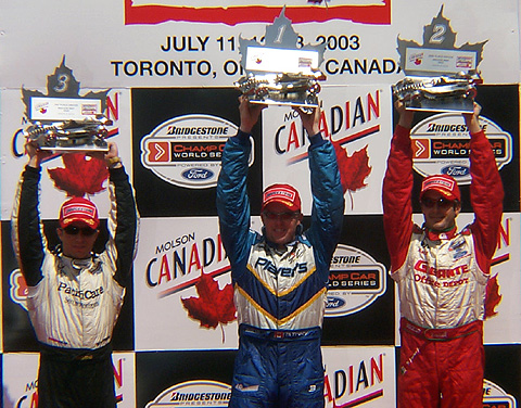 Podium Finishers Holding Up Trophies