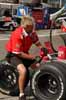 Crew Member Scrubbing Tire of Buildup Thumbnail