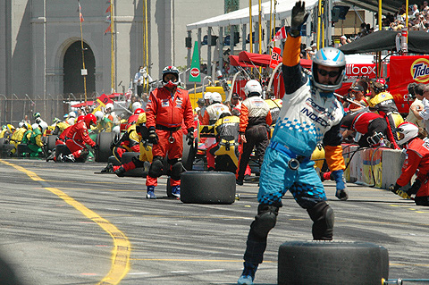 Crew Waving Their Drivers Into The Pit Box