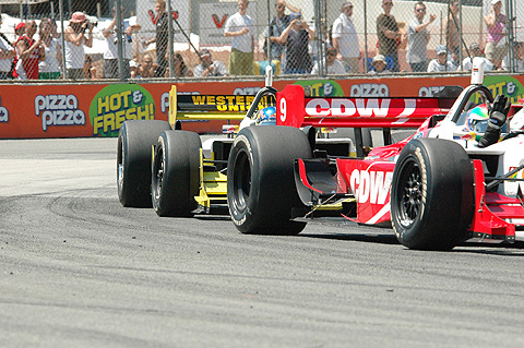 Justin Wilson Waves Hand in Car