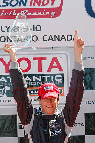 Antoine Bessette Holding Up Trophy On Podium