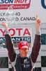 Antoine Bessette Holding Up Trophy On Podium Thumbnail