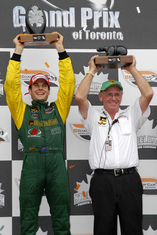 Will Power and Derrick Walker Hold Up Trophies