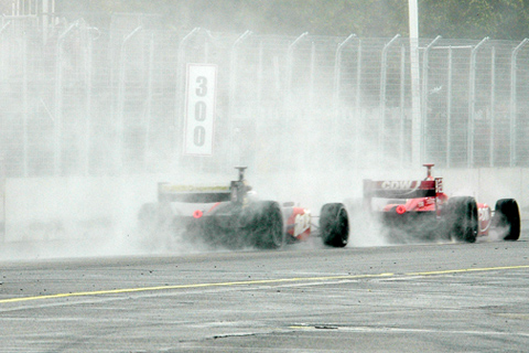 Two Cars Obscured in Rooster Tails of Spray