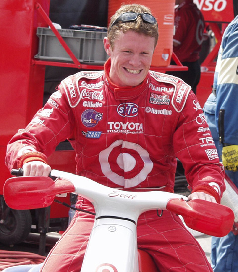 Scott Dixon Riding A Scooter